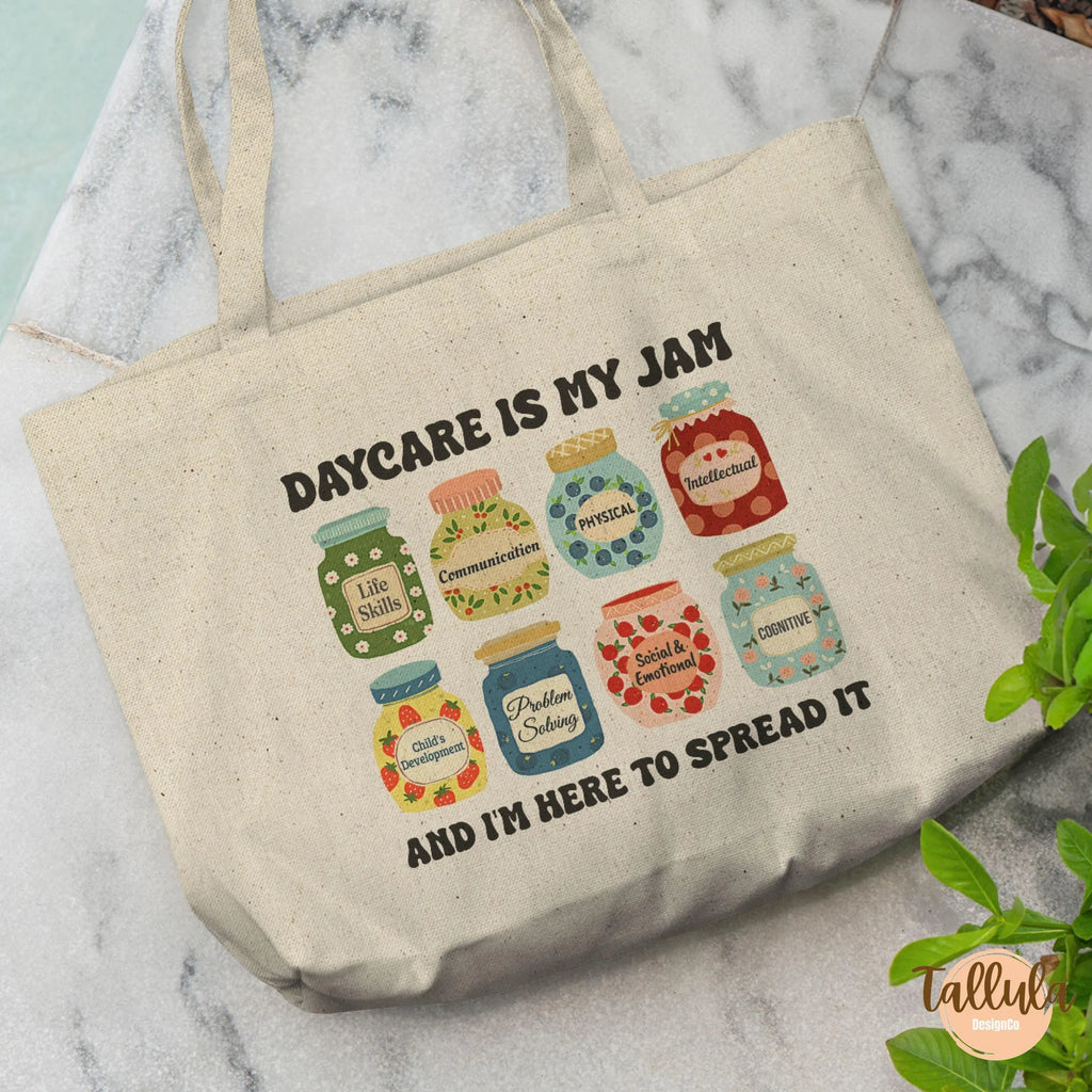 A natural canvas tote bag with a printed graphic of colorful jam jars and the text 'DAYCARE IS MY JAM AND I'M HERE TO SPREAD IT', Featuring descriptive words related to Daycare, childcare, pre-k, early childhood education
