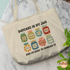 A natural canvas tote bag with a printed graphic of colorful jam jars and the text 'DAYCARE IS MY JAM AND I'M HERE TO SPREAD IT', Featuring descriptive words related to Daycare, childcare, pre-k, early childhood education