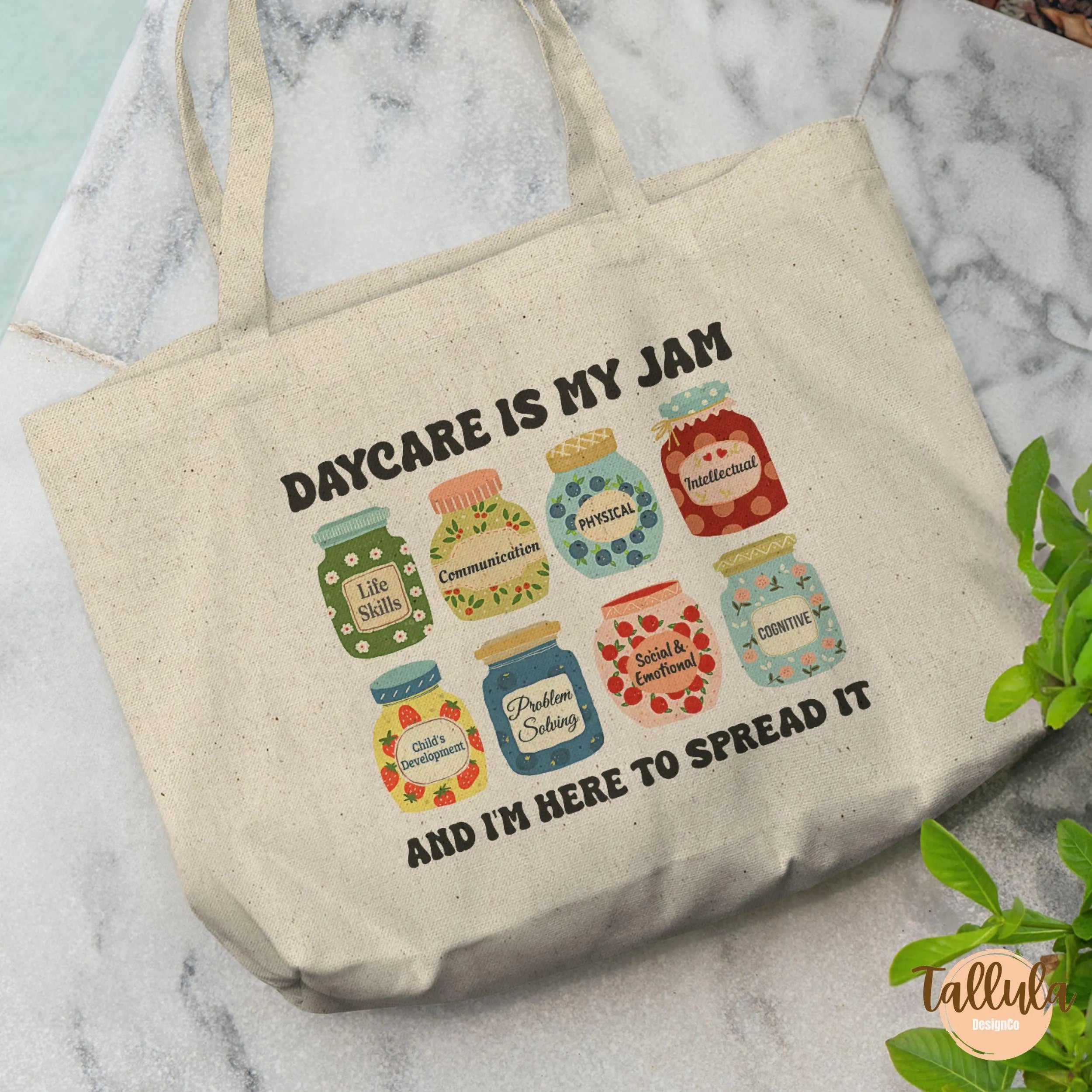 A natural canvas tote bag with a printed graphic of colorful jam jars and the text 'DAYCARE IS MY JAM AND I'M HERE TO SPREAD IT', Featuring descriptive words related to Daycare, childcare, pre-k, early childhood education