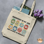 A cream canvas tote bag with a printed design of colorful jam jars and the text "Midwifery IS MY JAM", featuring descriptive words related to midwife, doula, postpartum nurse, lactation consultant, mother baby nurse