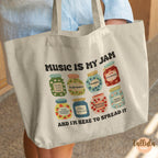 A canvas tote bag with a colorful graphic of jam jars and the text 'MUSIC IS MY JAM' and 'AND I'M HERE TO SPREAD IT'. Featuring descriptive words for each jar related to music educator, music teacher, performer.