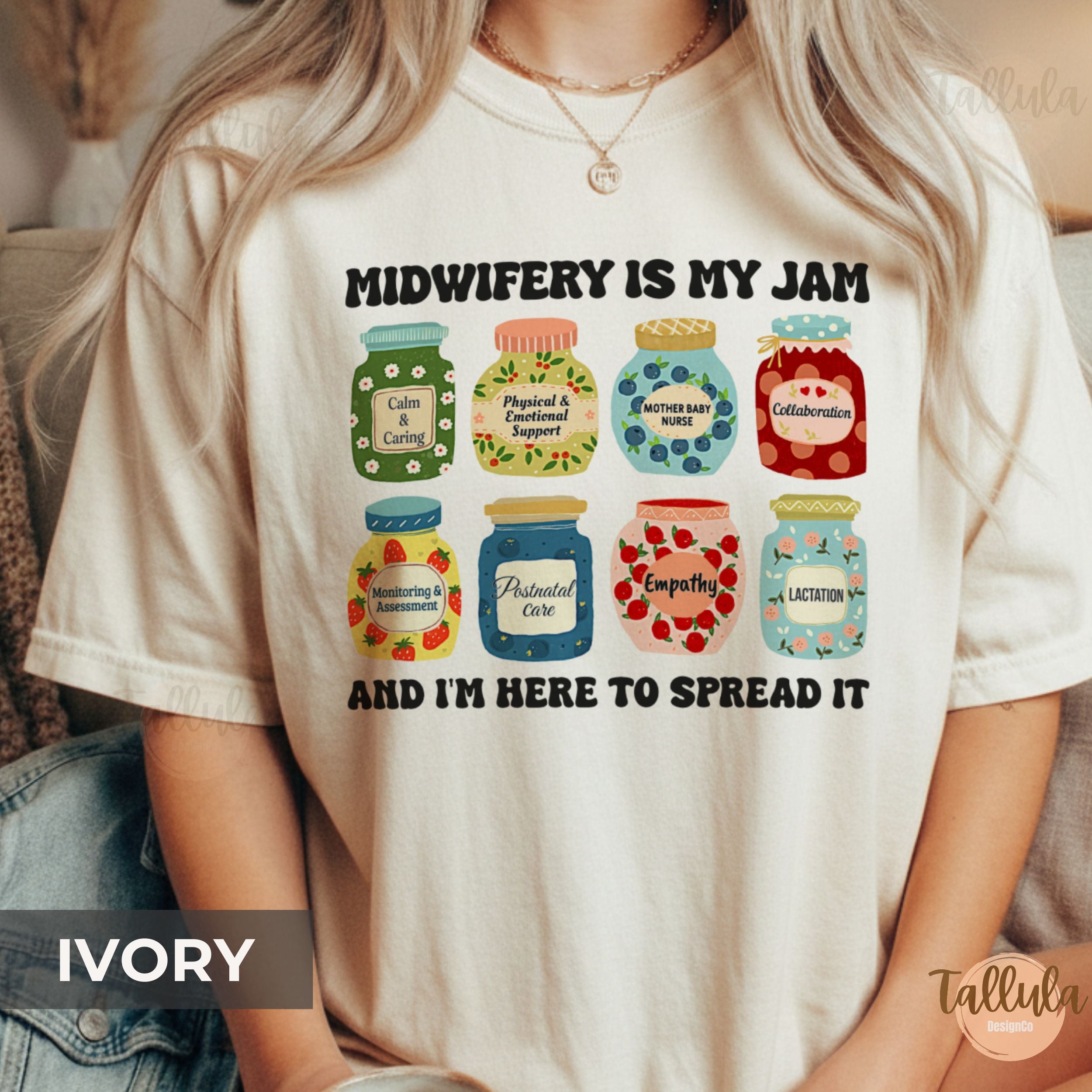 A comfort colors graphic t-shirt with the text 'MIDWIFERY IS MY JAM AND I'M HERE TO SPREAD IT' and eight colorful illustrated jam jars, featuring descriptive words on each jar related to midwife, doula, mother baby nurse, postpartum nurse, perinatal nurse